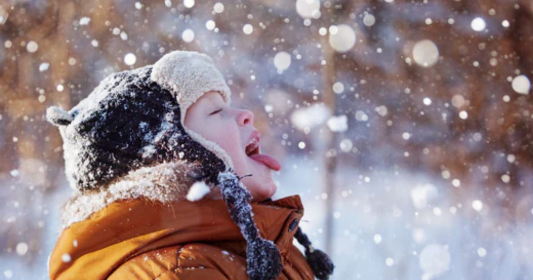 Boy eating snow and excited he use the snow day calculator