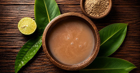 Instant kava prepared in a traditional coconut shell with kava powder, tropical leaves, and fresh lime